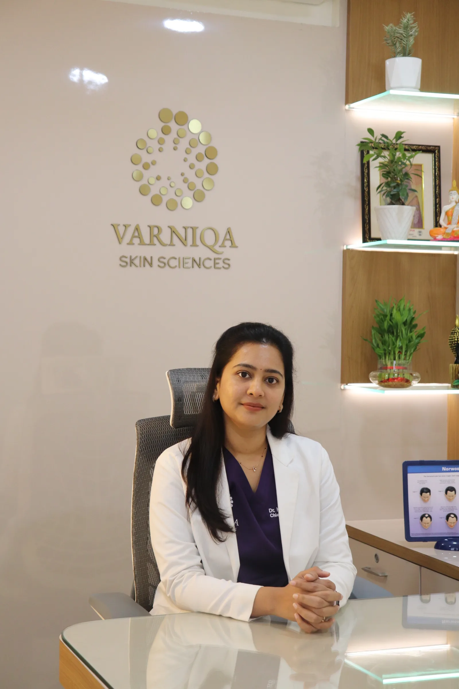 Dr. Manvitha Poluri seated in the consulting room at Varniqa Skin Sciences, Nallagandla